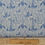 Thumbnail: Blue patterned fabric with floral design and ruler, The Fabric Squirrel.