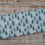 Thumbnail: Fabric with a forest pattern, featuring trees and clouds, on wooden background. The Fabric Squirrel
