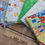 Thumbnail: Various colorful fabric patterns arranged with ruler, THE FABRIC SQUIRREL on wood surface.