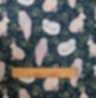 Fabric with rabbits, owls, and cats amongst foliage; The Fabric Squirrel.