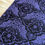 Thumbnail: Purple fabric with black spiderwebs, stars, and moons on display, closeup shot.