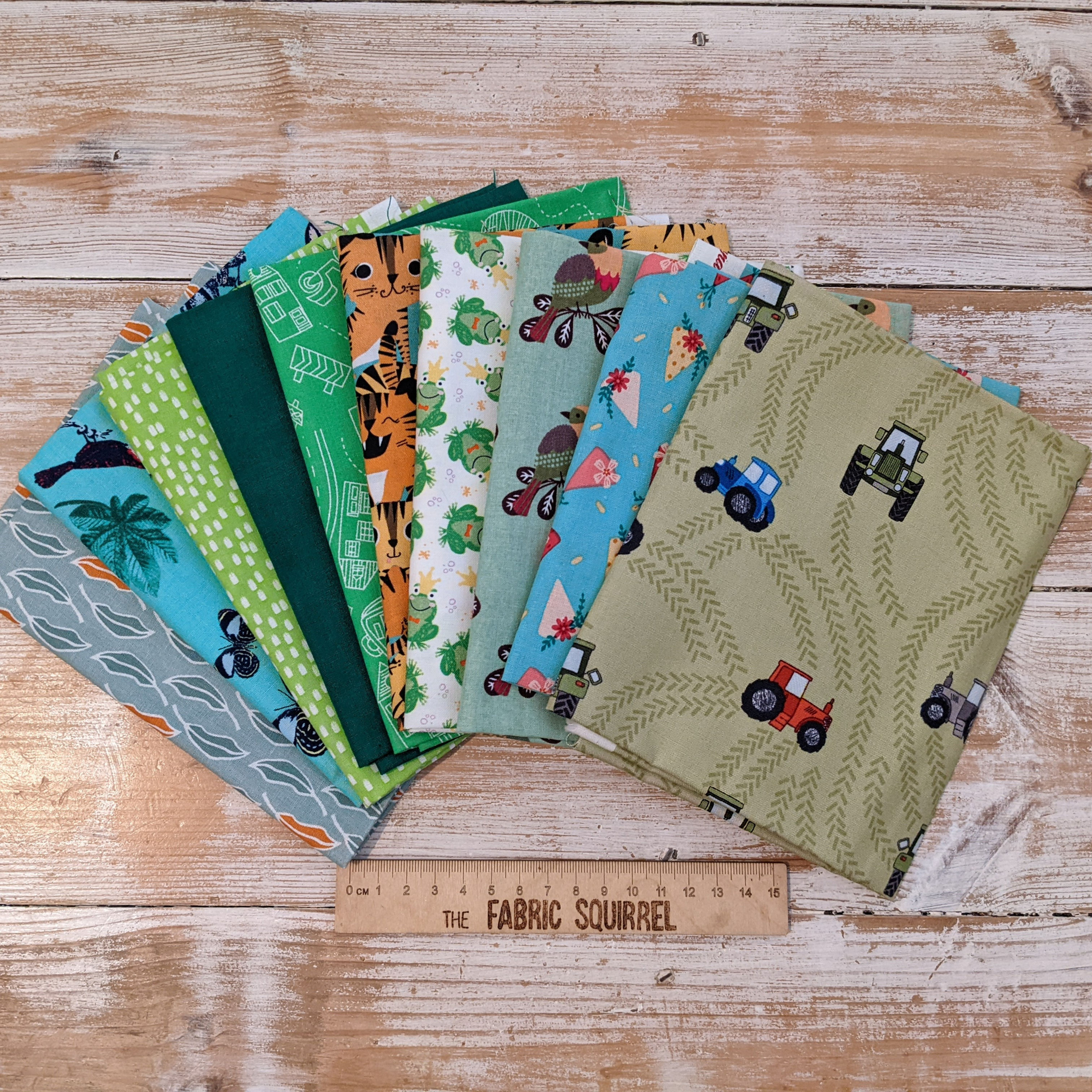 Various colorful fabrics with different patterns displayed on wooden surface The Fabric Squirrel