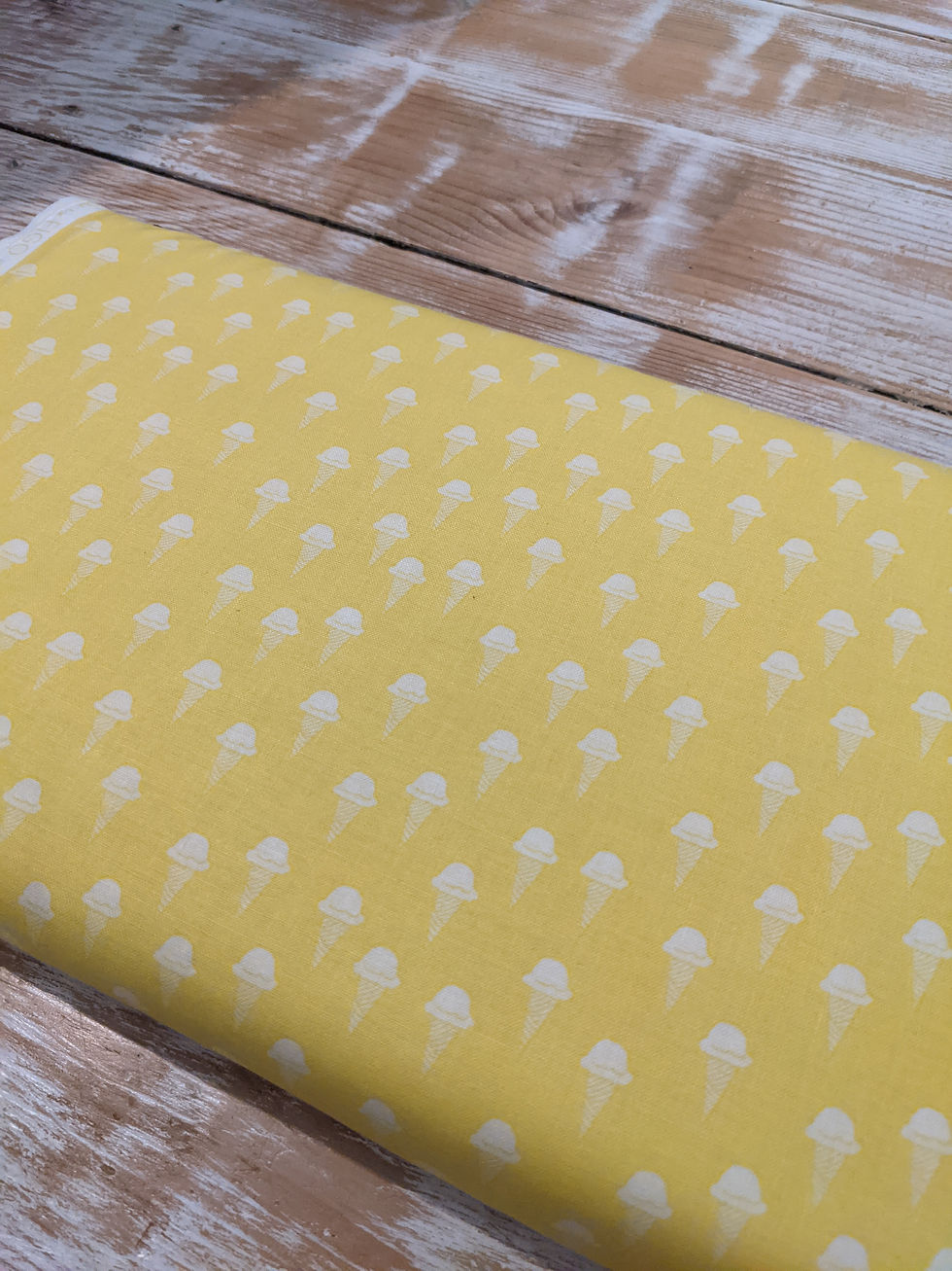 Thumbnail: Yellow fabric with white pattern on a wooden surface The Fabric Squirrel