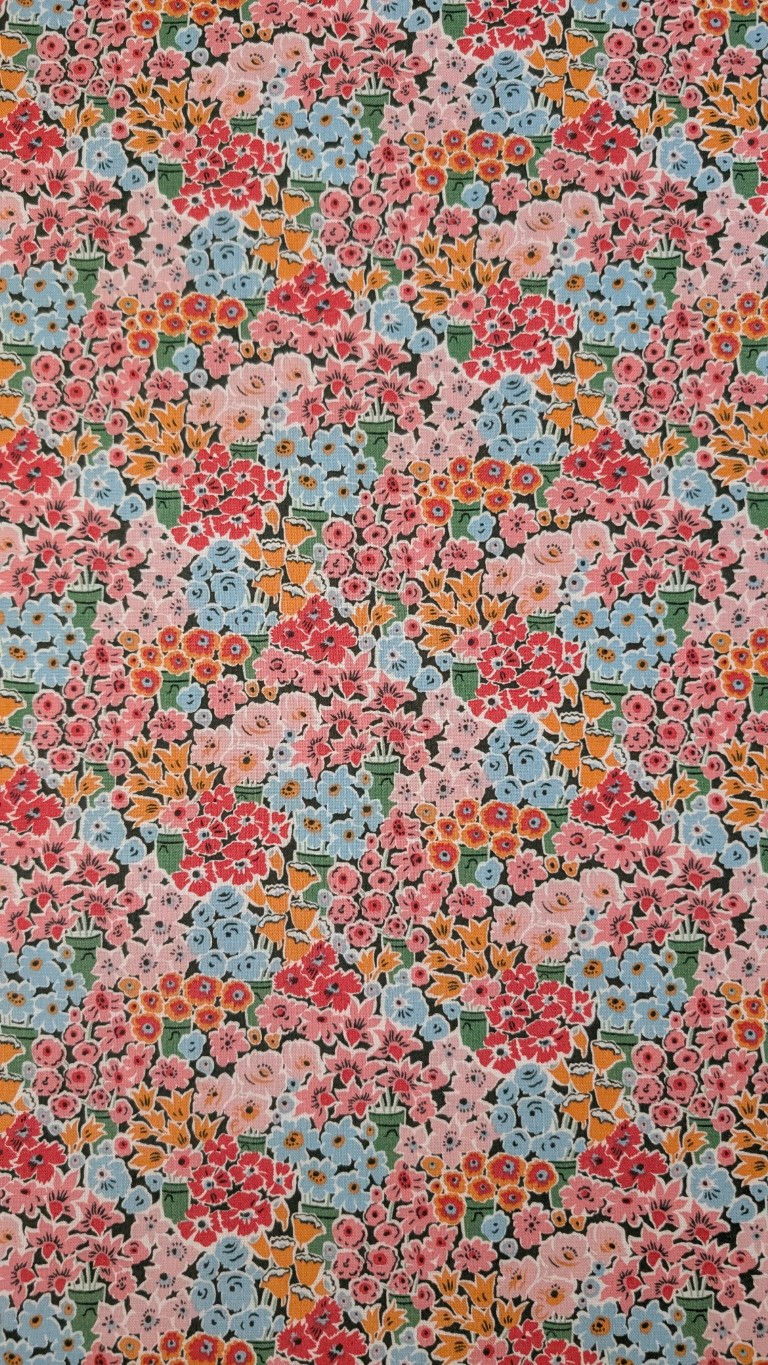 Thumbnail: Floral fabric with pink, red, blue, and yellow flowers; close-up view.