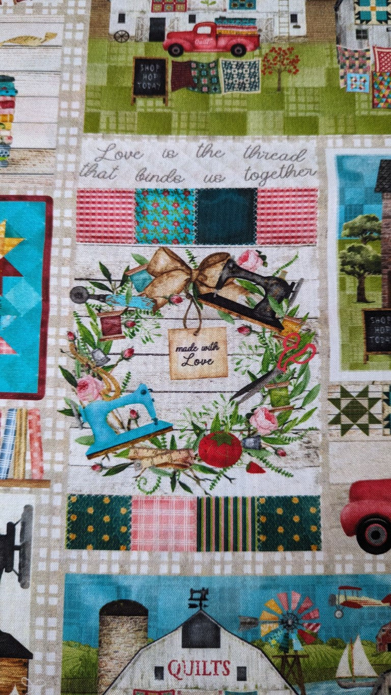 Thumbnail: Quilting wreath with saying, “Made with Love,” scissors, and more on fabric.