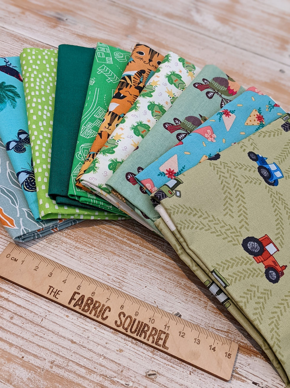 Thumbnail: Various colorful fabric patterns with a wooden ruler and The Fabric Squirrel.