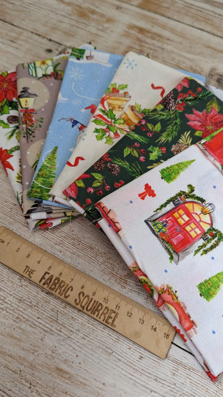 Thumbnail: Festive Christmas fabric with various patterns, ruler, and The Fabric Squirrel.
