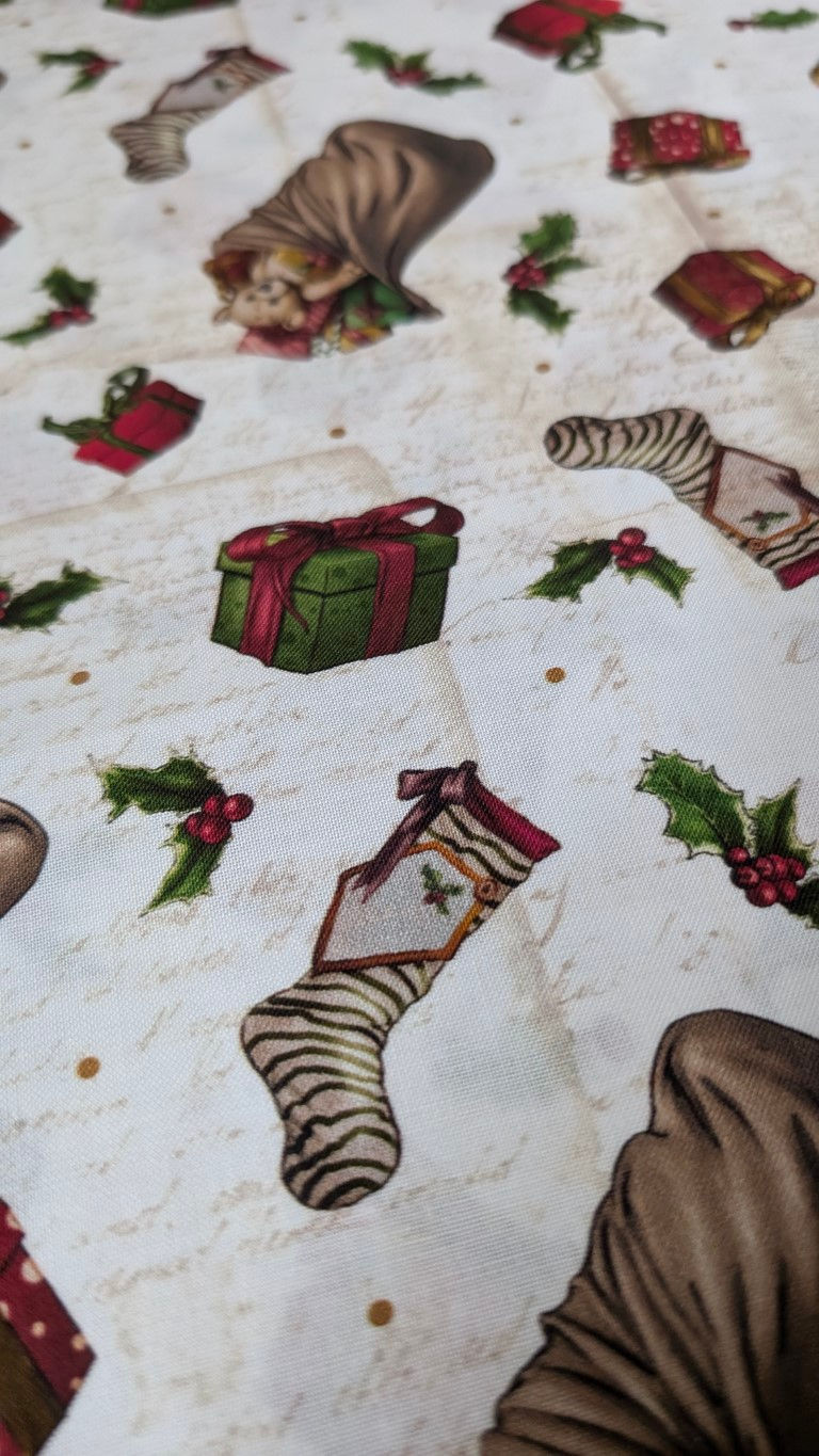 Thumbnail: Christmas fabric pattern with gifts, holly, and stockings; The Fabric Squirrel.