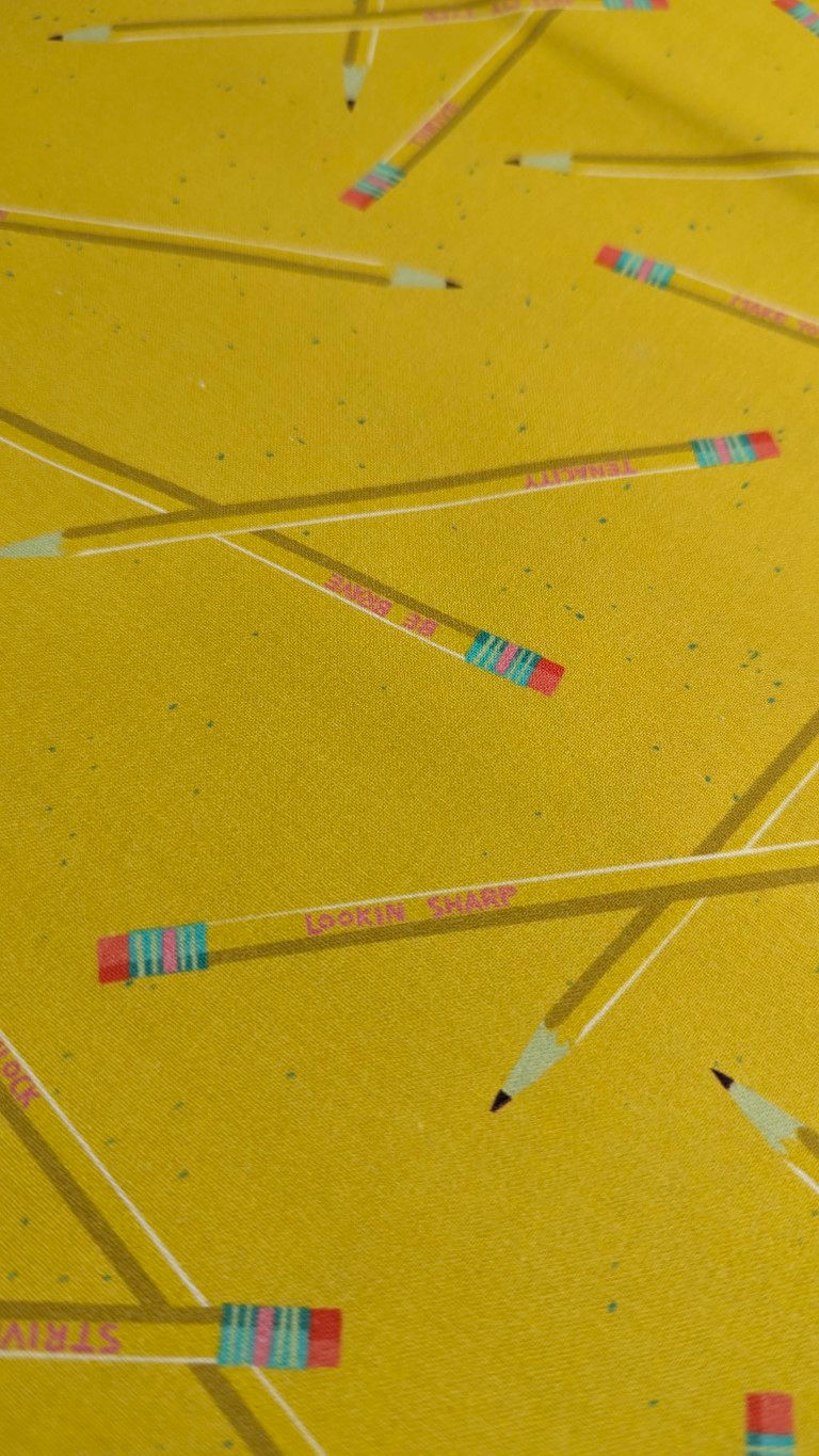Thumbnail: Pencils on yellow fabric: Pencil Stay Sharp Fabric - 9 to 5 from Paintbrush Studio Fabrics.