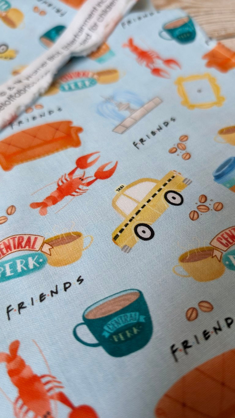 Fabric with Friends TV show icons and text on a light blue background.