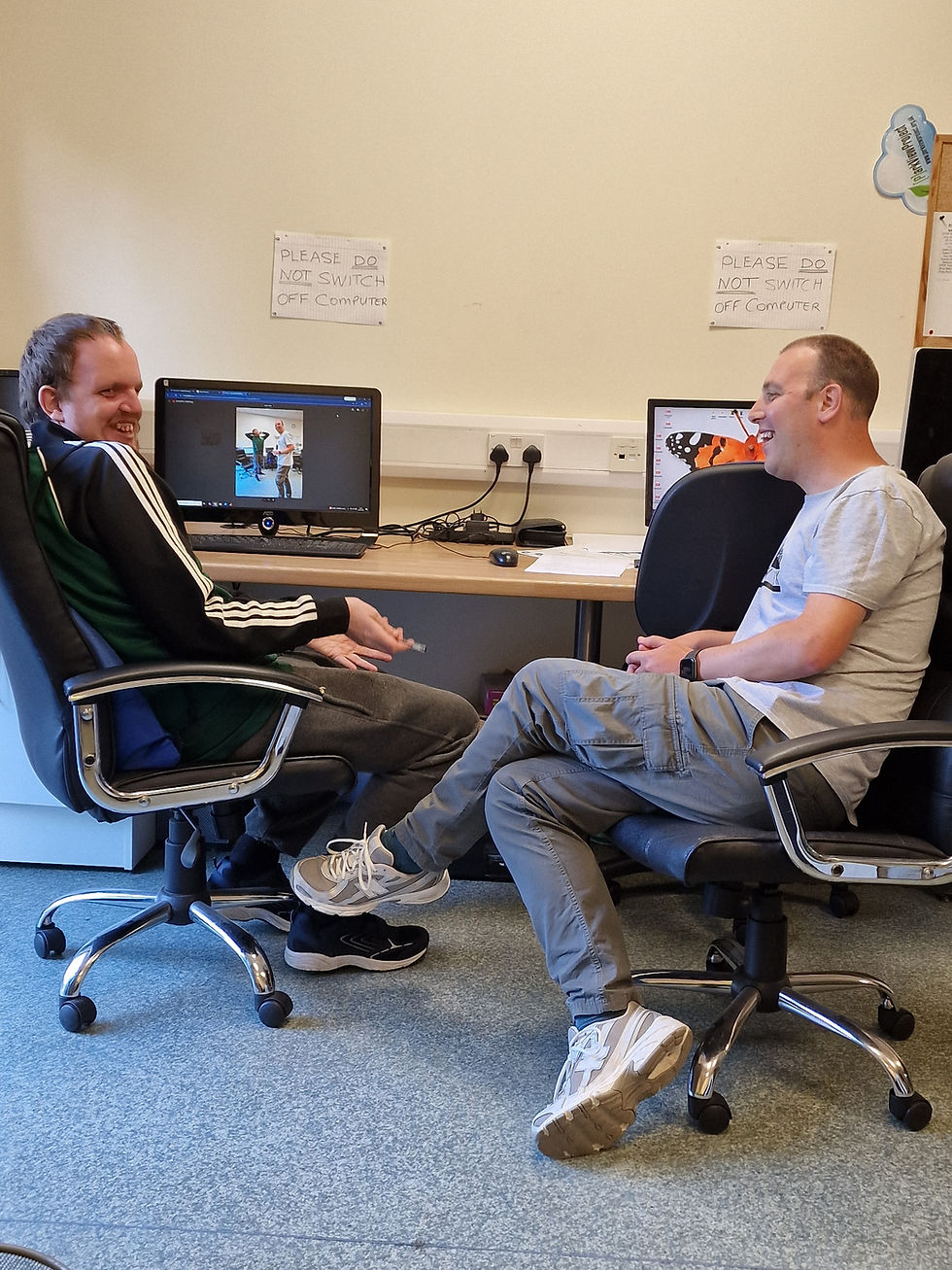 Volunteer Online Buddies at PC station designing new posters for community libraries.