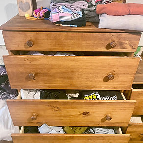 Close up of cluttered clothes dresser