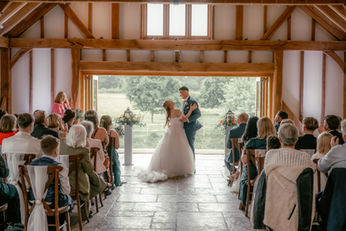 Bride walking down aisle at Brookfield Barn