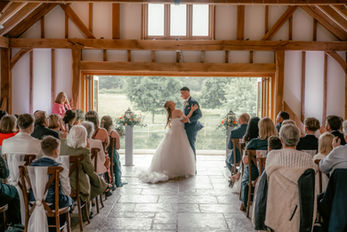 Bride walking down aisle at Brookfield Barn