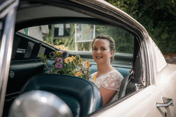 Bride sitting in wedding car before the ceremony