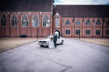 Bride and groom in front of Ardingly College building