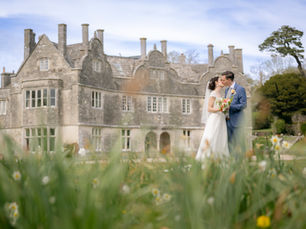 Bride and Groom kissing in front of Warmwell House, Dorset 