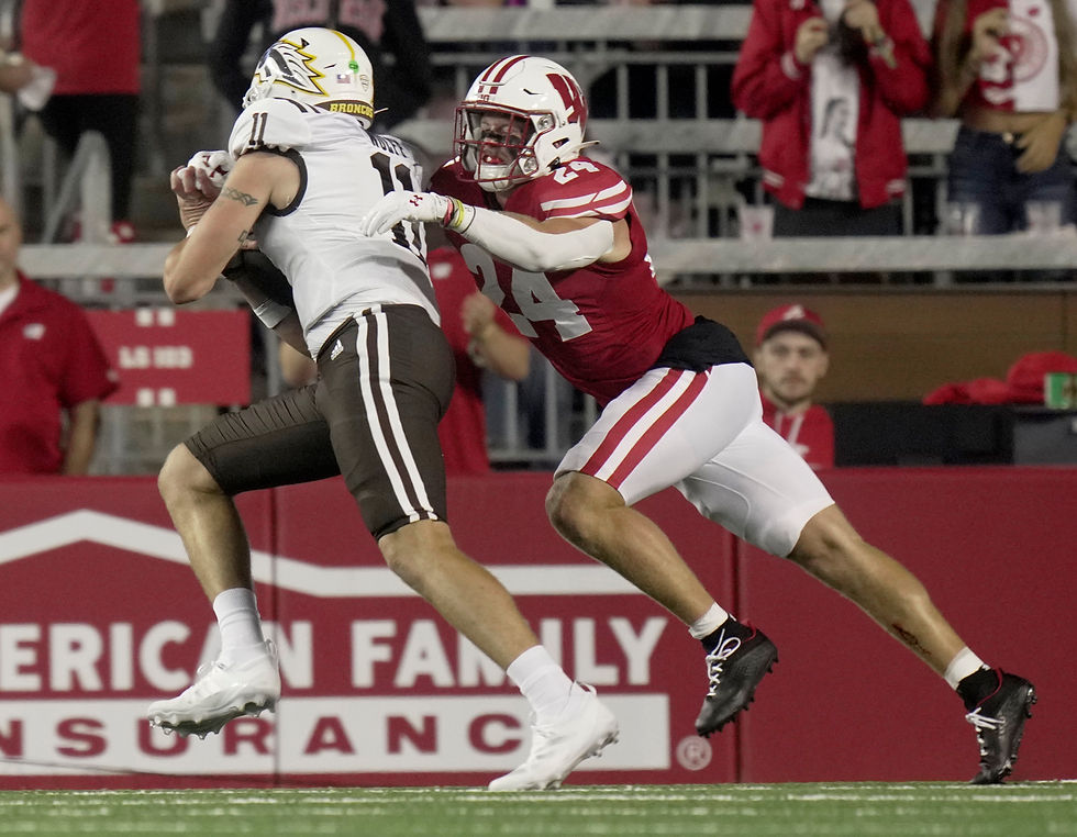 Wisconsin safety Hunter Wohler (24) stops Western Michigan quarterback Hayden Wolff (11) short of a touchdown during the second quarter of their game at Camp Randall Stadium.