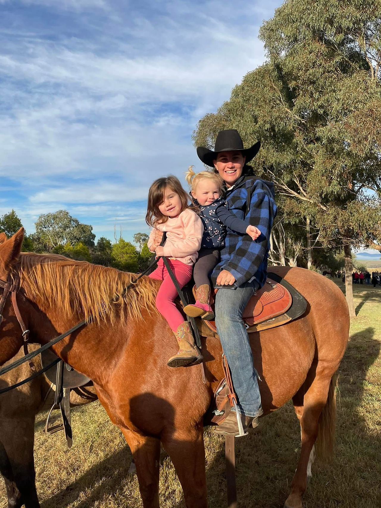 Kellie with her girls on a horse 