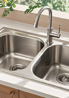 Heavy-gauge brushed stainless steel kitchen sink with deep basin, sound-dampening pads, and rear drain—ideal for contemporary kitchens.
