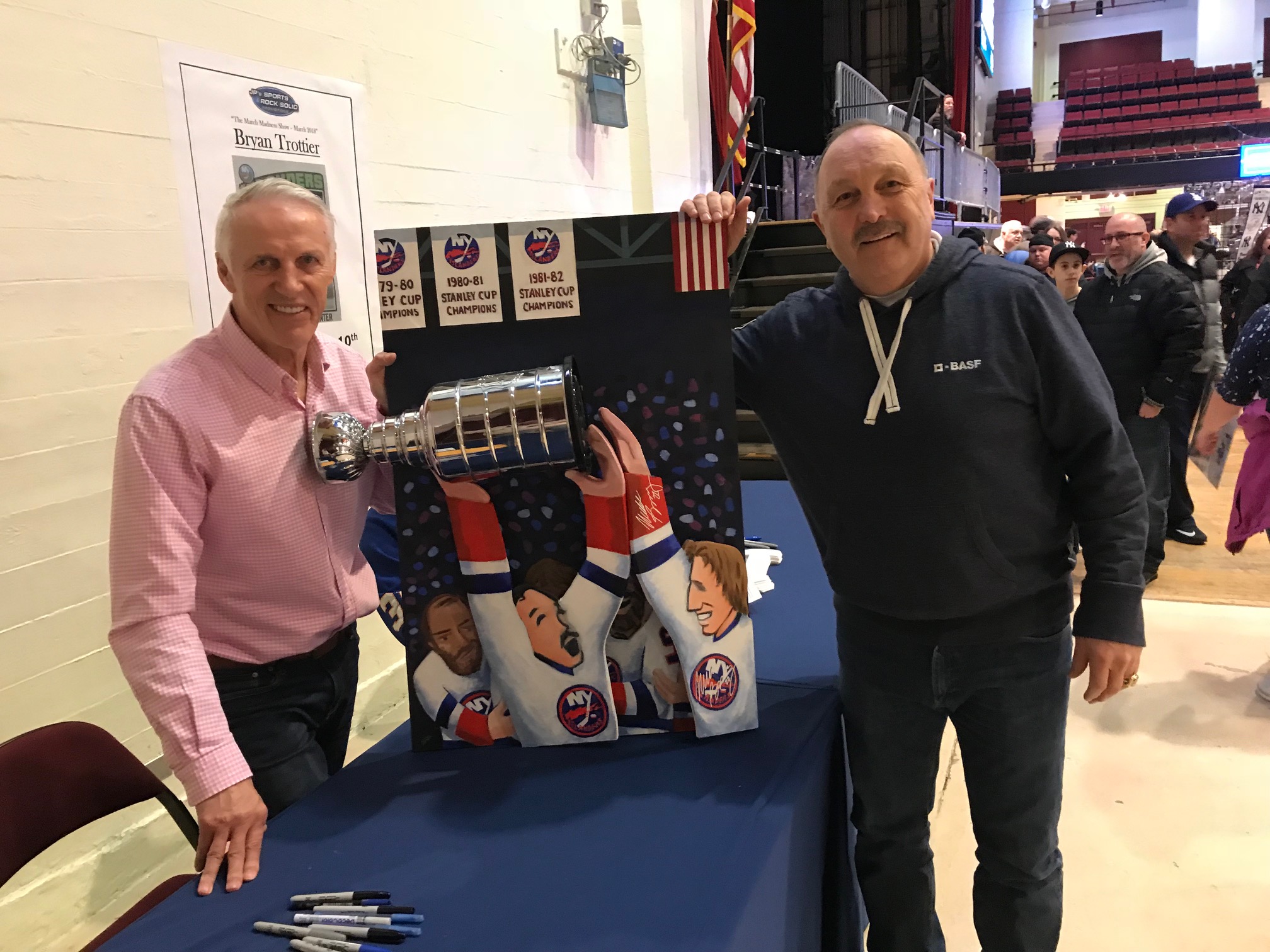 Sax Trottier and Bossy holding painitng.
