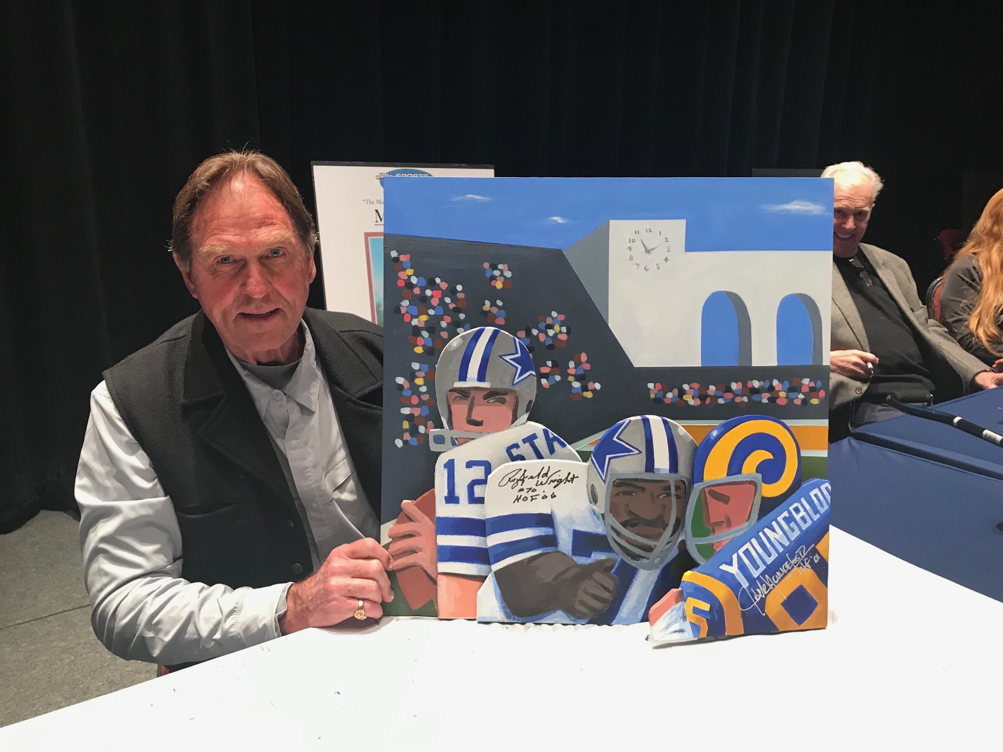 Jack Youngblood holding painting