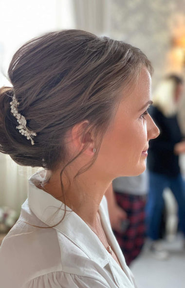 Bridal hair specialist Mandy from Hair Ups styling a bride on her wedding morning in Scotland