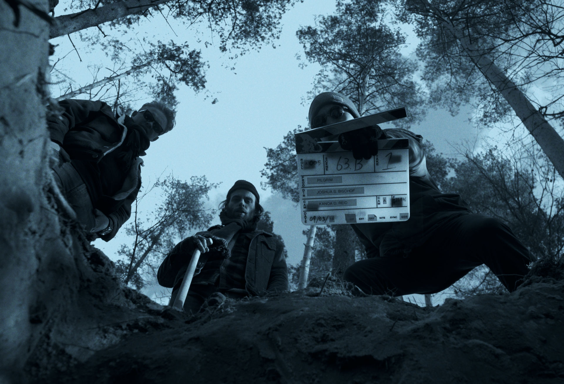 cast and crew standing over grave before filming a scene.jpg