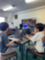 Children participating in a programming class at Elev8 Summer Camp in Tokyo, learning with laptops and Minecraft in a fun, interactive environment.