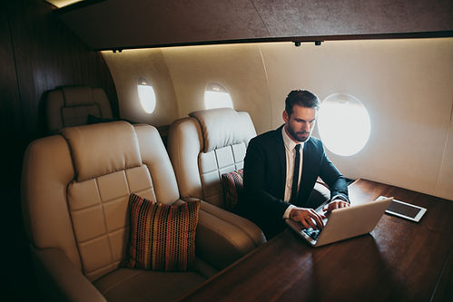 businessman flying on his private jet