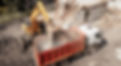 Excavator bucket loads industrial debris into truck. Process of demolishing and destructio
