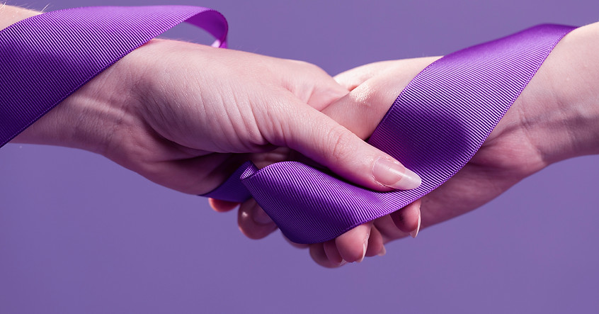 women-hands-holding-purple-satin-ribbon.jpg