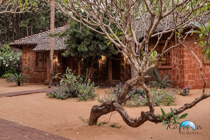 Exterior of horseshoe-shaped beach villa cluster at Raman