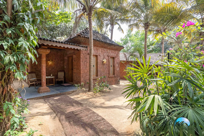 Cottage entrance under trees and red brick walls