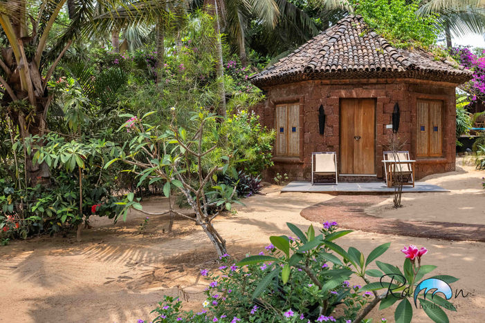 Octagonal Cottage surrounded by trees and greenery