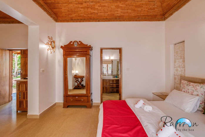 Wooden wardrobe and mirror corner in bedroom.