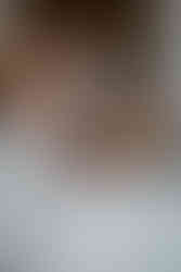 The bride and groom hold hands while they cut the cake.