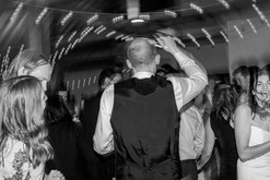bride, groom and wedding guests dancing