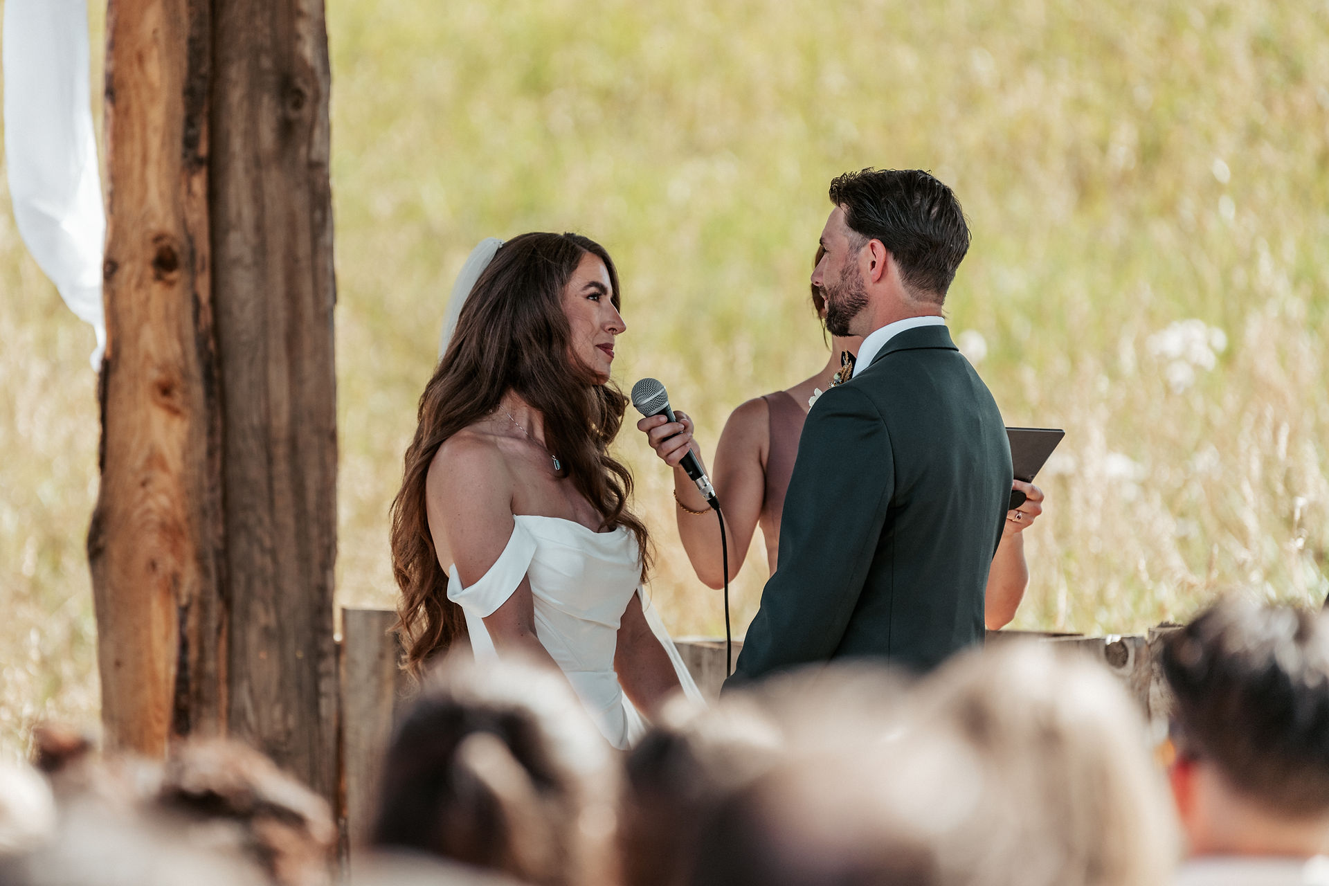The bride and groom stand at the alter reciting their vows.