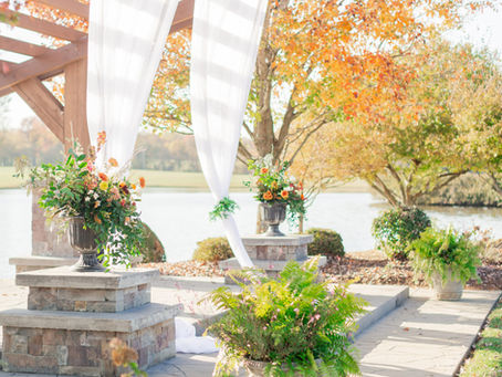 Reception space featuring rustic elegance with greenery, candles, and curated rentals at Adaumont Farm.