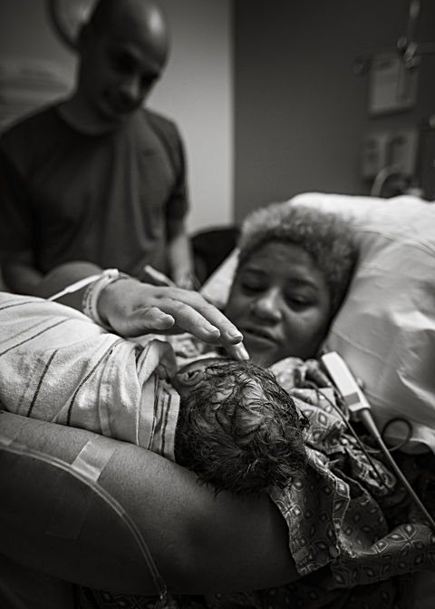 Newborn baby Birth photography in Portland, Maine - Birth Photography in hospital mom holding baby