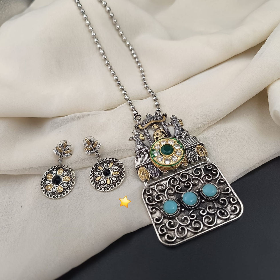 Antique bohemian jewelry set featuring an intricately carved oxidized centerpiece with dangling charms.
