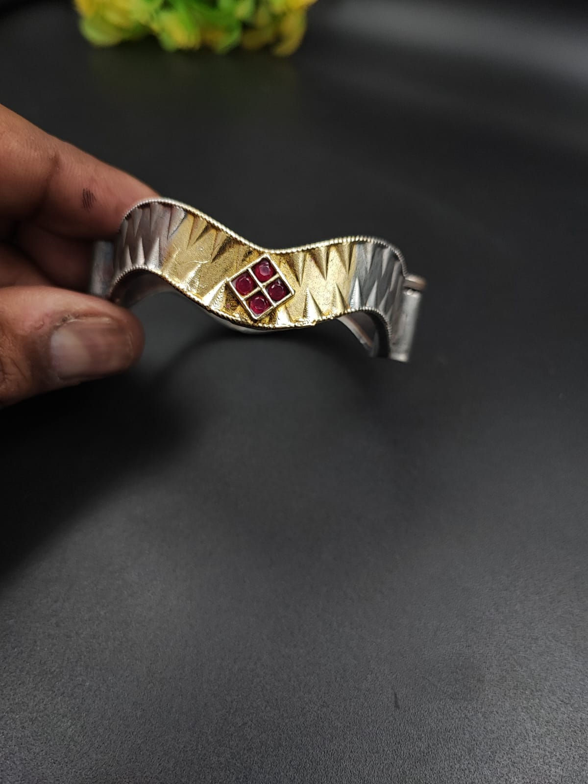 Two-tone silver and gold cuff bracelet with corrugated texture and four stone centre in red, pearl, blue and green variants,