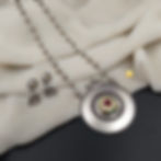 Ethnic boho jewelry set displaying a carved antique oxidized centerpiece and matching drop earrings.