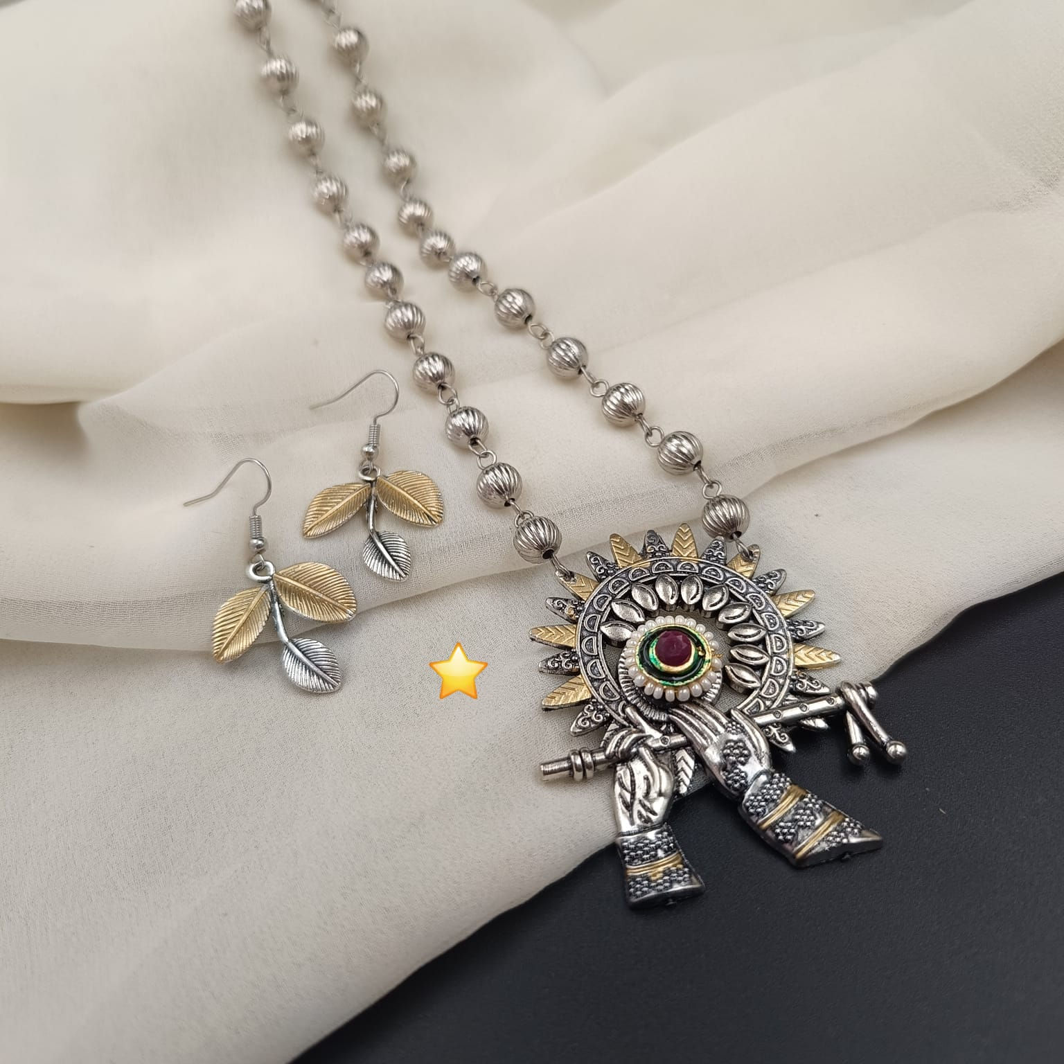 Handcrafted silver oxidized jewelry necklace set featuring a detailed antique centerpiece and matching drop earrings.