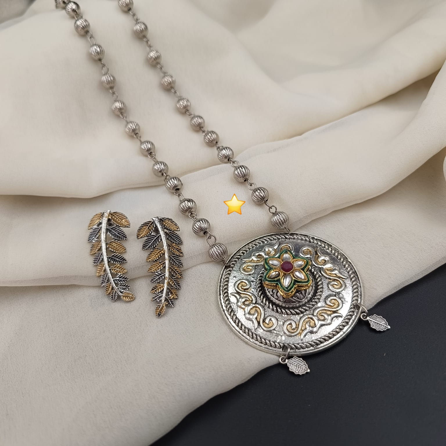 Handcrafted festive two tone necklace set featuring an ornate oxidized center pendant and matching drop earrings