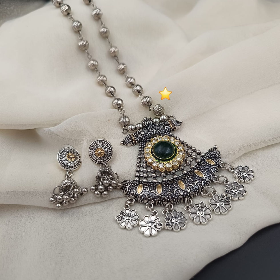 Handmade ethnic jewelry set displaying an oxidized metal statement pendant paired with matching dangle earrings.