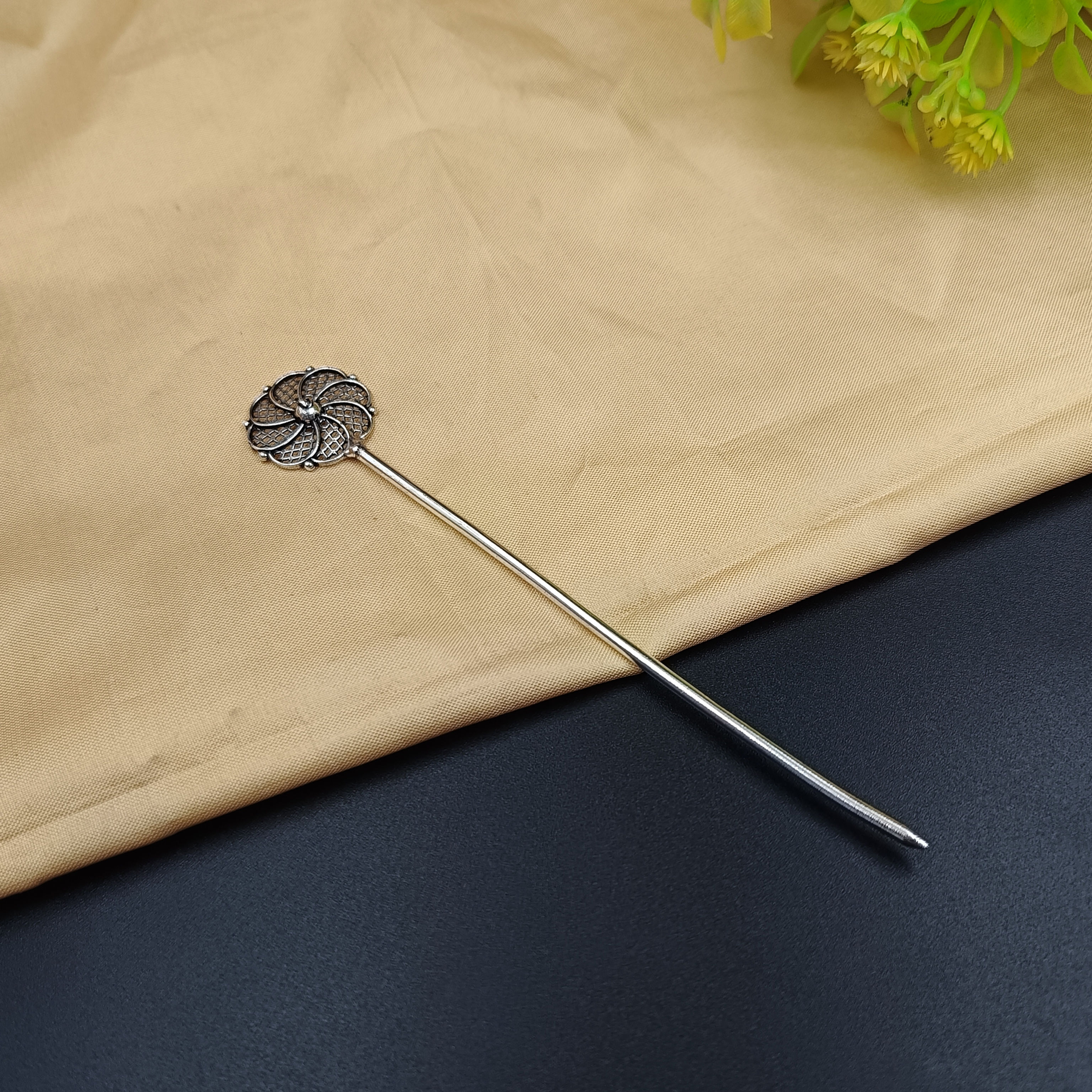 Round spiral-inspired oxidised hair stick with traditional geometric detailing.