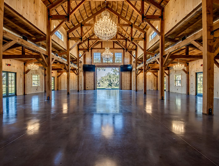 Grand hall at The Celebration Barn with chandeliers and rustic charm