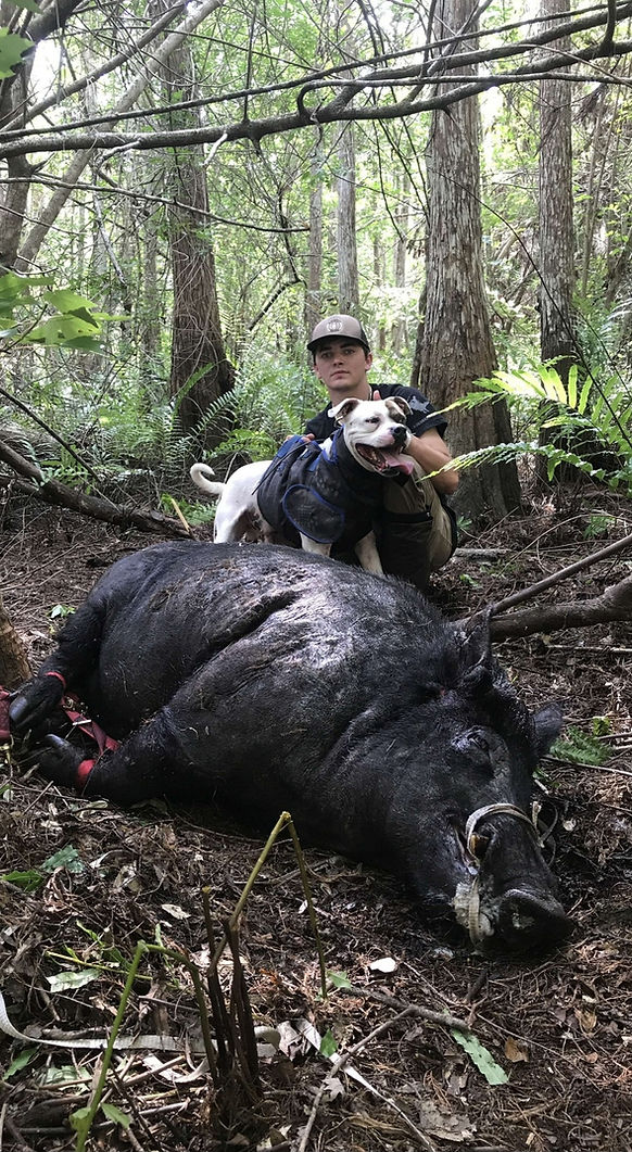 Hunter and dog after successful Wild Hog hunt